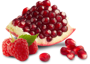 a pomegranate  and raspberries 